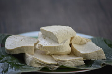 Tofu, also known as bean curd or Tahu in Indonesia language, is a food prepared by coagulating soy milk fermentation and then pressing the resulting curds into solid white blocks of varying softness 