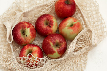 apples in basket on white table