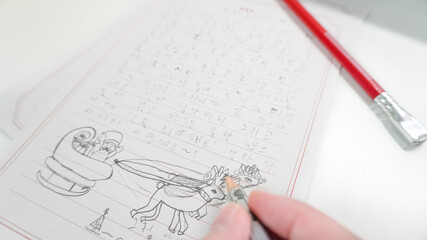 Seoul, South Korea - Dec. 3, 2021 : Little girle writing and drawing letter to Santa Claus at...