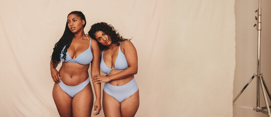 Body positive young women wearing blue underwear in a studio - obrazy, fototapety, plakaty