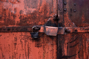 Close up old rusty metal door with lock. good texture.