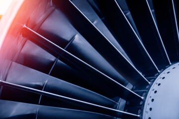 Closeup jet engine blades of airplane. Blue color tone