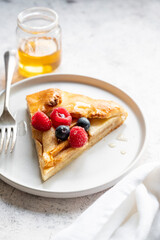 Apple tart or galette with cinnamon and fresh berries. Home baking.