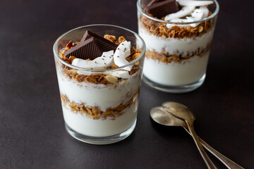 Granola with yogurt, coconut and chocolate. Muesli. Breakfast. Vegetarian food. Healthy eating.