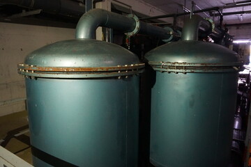Zwei alte blaue Filterkessel im Keller eines Schwimmbads