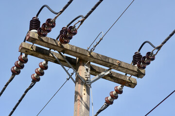 lot of wires and a telephone line on an electric pole
