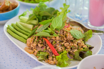 Spicy minced pork with red chili peppers and vegetables, Or Lab-Moo in Thailand food