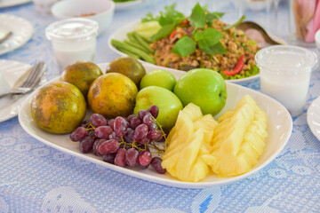 Assorted fruits on the dining table, pineapples decorated one by one arranged in a beautiful plate.