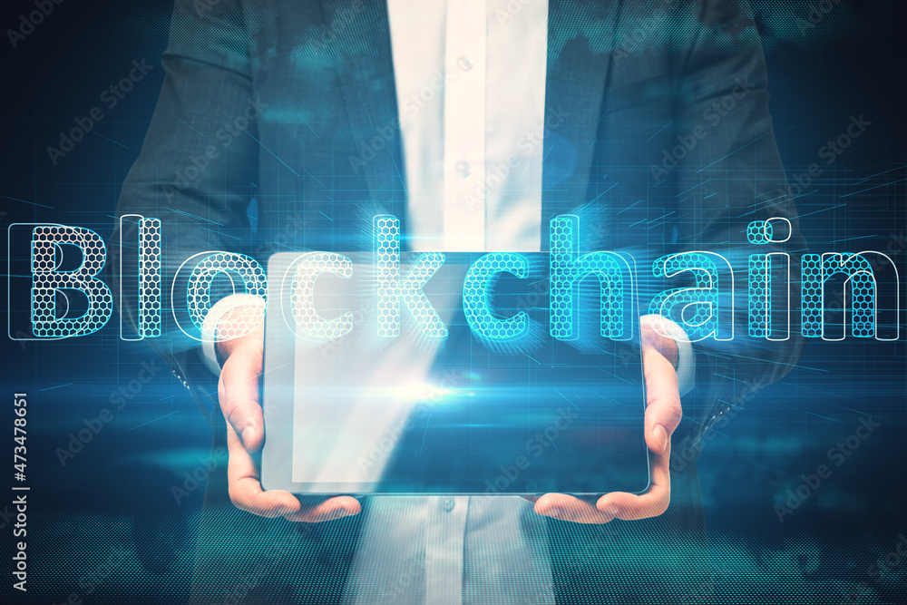 Poster close up of businessman hand holding tablet with creative glowing blockchain hologram on dark backgr