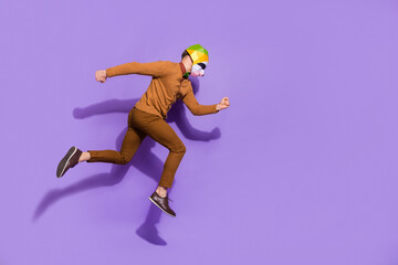 Fototapeta na wymiar Full size profile portrait of active energetic red panda mask guy running isolated on violet color background