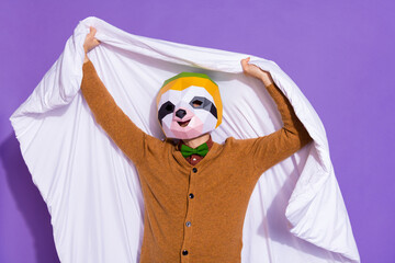 Photo of young man hold duvet bedroom sleepy incognito red panda isolated over purple color...