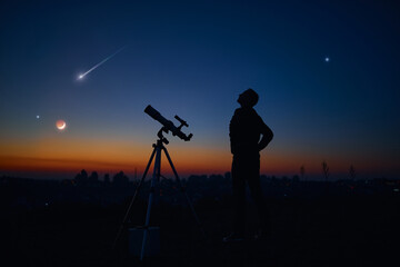 Silhouette of a man and telescope under the starry skies.