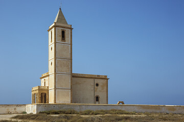 Side view of the church of the Salinas de Cabo de Gata, next to the beach of the Mediterranean Sea