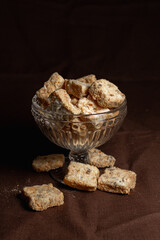 Pile of sweet Turkish Delight dessert served in glass on brown table in dark studio 