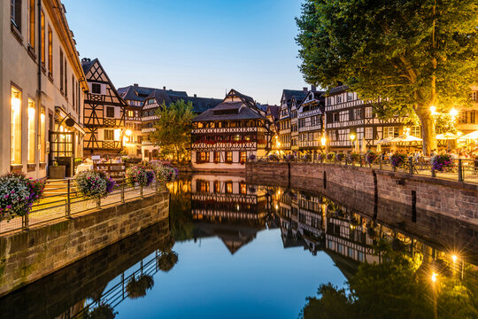 France, Bas-Rhin, Strasbourg, Long exposure of half-timbered houses reflecting in Petite FranceIll river canal at dusk