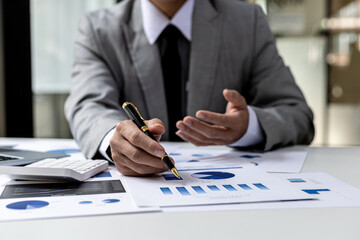Business finance person is reviewing a company's financial documents prepared by the Finance Department for a meeting with business partners. Concept of validating the accuracy of financial numbers.