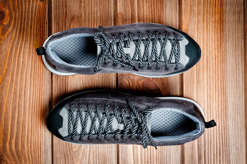 Men's gray-brown sports shoes laced with laces. Close-up shot.