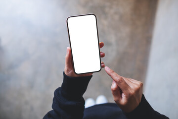 Top view mockup image of a woman holding and using mobile phone with blank desktop screen