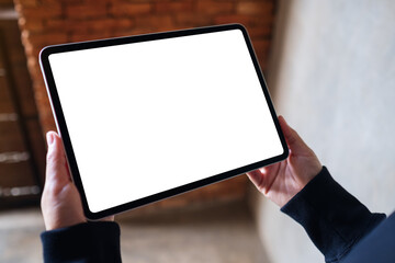 Mockup image of a woman holding digital tablet with blank white desktop screen