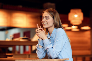 Business woman in a cafe in the summer outdoors on vacation