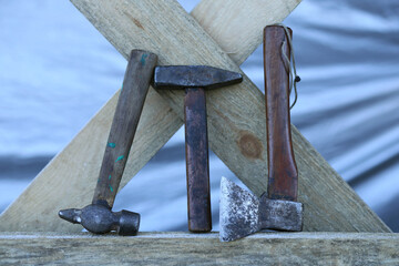 Very simple tools for building a wooden structure, two hammers and a small ax, with a mahogany handle.