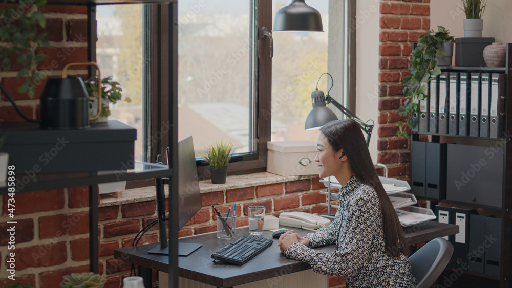Poster entrepreneur using video call on computer for communication, talking to colleague about business pro