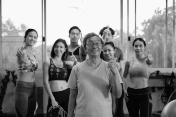 Fototapeta premium Senior man and young group people, Friends different ages in gym working out