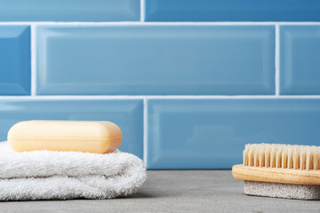 Obraz na płótnie Canvas Soap and toiletries on shelf in blue bathroom