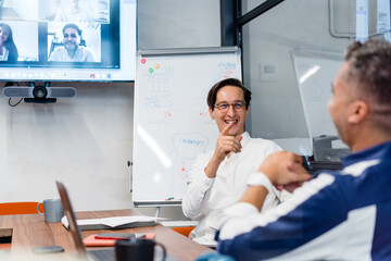 Colleagues in conference room during online meeting