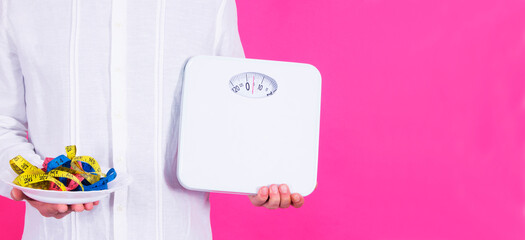 holding plate with colored tape measures and scales. diet and eating concept