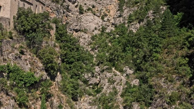 Moustiers Sainte Marie France Aerial v2 dramatic drone fly through rocky canyon capturing beautiful landscape with vegetation growing in the crack of limestone mountain walls - July 2021