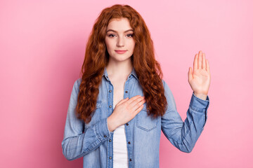 Photo of young girl hand on heart make oath promise tell the truth isolated over pastel color background - obrazy, fototapety, plakaty