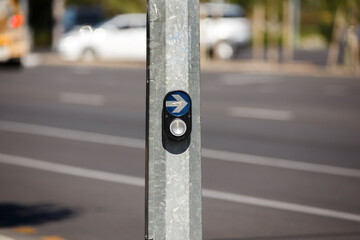 Pedestrian crossing traffic button with an arrow