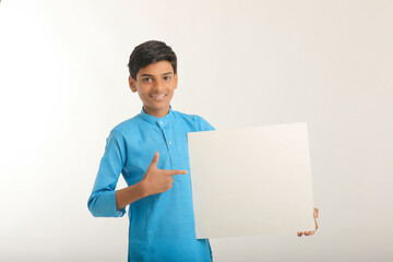 Indian little child in traditional wear and showing white board.