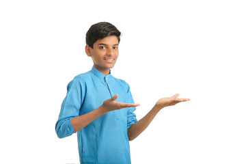 Indian boy in traditional wear and giving hand expression on white background.