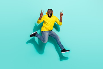 Fototapeta premium Full length photo of excited guy jump make v-sign friends greeting isolated over cyan color background