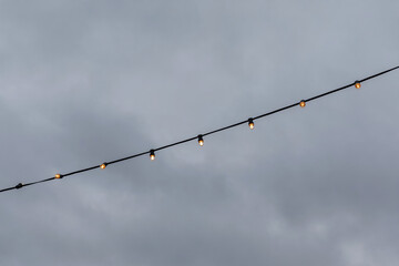 light bulb garlands against the grey sky