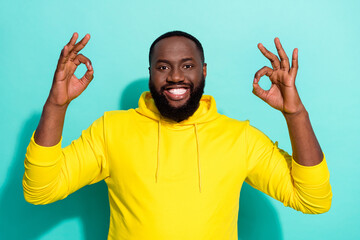 Photo of positive guy promoter show okey symbol suggest bargain promo isolated over cyan color...