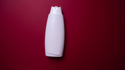 bottle of lotion or shampoo on colored background