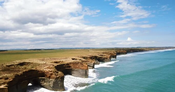Aerial reveals dramatic jagged rocky outcrops and sinkholes along coastline