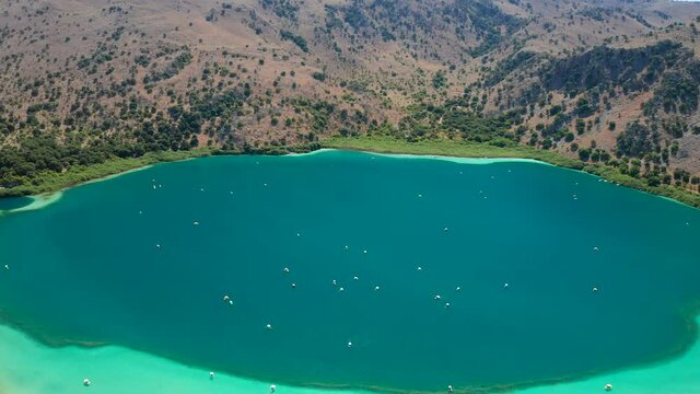 Aerial pullback reveal freshwater Lake kournas water color phenom, Crete Island