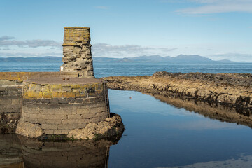 Dunure harbour entrance looking across to Arran. Old fishing port on Scotland's West coast.