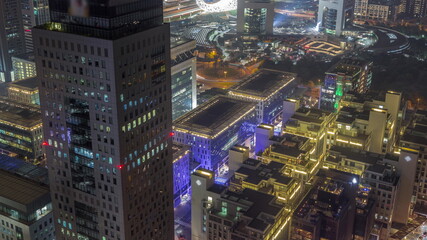 Fototapeta na wymiar Office tower located in the Dubai International Financial Centre night timelapse