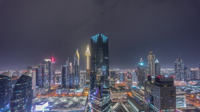 Panorama of futuristic skyscrapers in financial district business center in Dubai all night timelapse