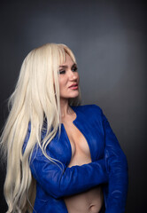 Fototapeta premium blonde, studio portrait of a young woman on a dark background