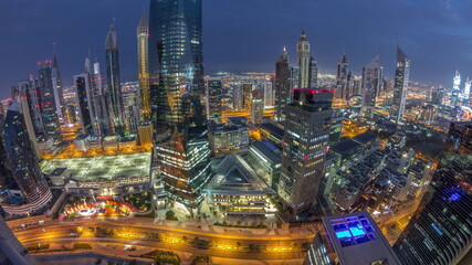 Panorama of futuristic skyscrapers in financial district business center in Dubai night to day timelapse