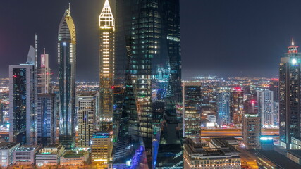Obraz premium Financial center of Dubai city with luxury skyscrapers all night timelapse, Dubai, United Arab Emirates