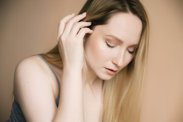 Fototapeta premium Portrait of a beautiful young woman with blue eyes.