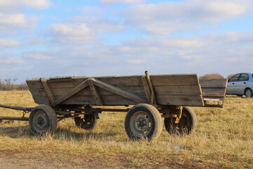 Horse-drawn carriage against a cloudy sky