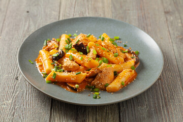 Traditional Korean Tteokbokki rice noodles with chicken, vegetables and shitake mushrooms. Prepared in a pan.